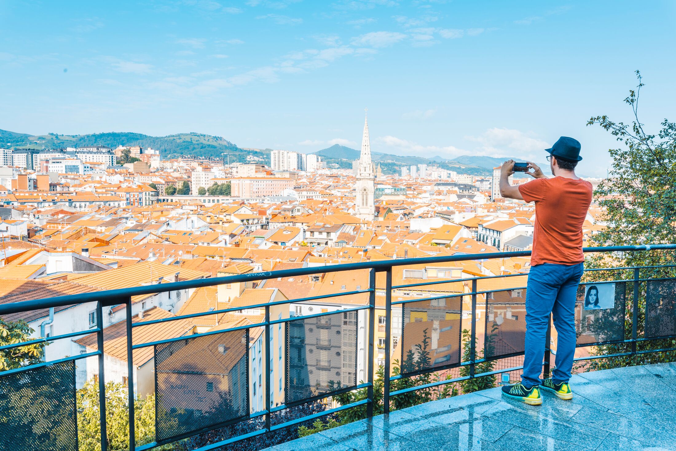 One man taking snapshot from a viewpoint over the old town (Casco Viejo) in Bilbao, Spain.
